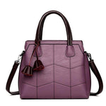 Purple leather cross body handbags with top handles