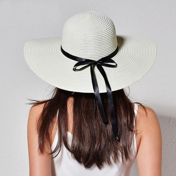 Large brimmed white straw hat