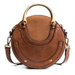 Brown round crossbody bag with metal handles