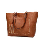 Brown leather tote bag with tassels
