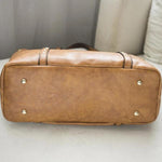 Leather brown tote bag with under rivets