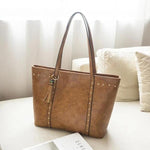 Brown leather tote bag with pockets and zipper