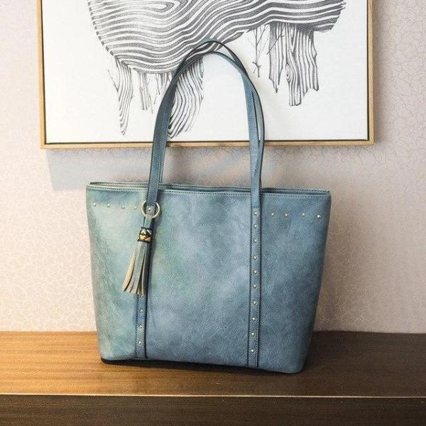 Blue leather tote bag with pockets and zipper