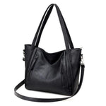 Black leather tote bag with zipper and shoulder strap