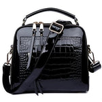 Black shiny leather crossbody bags with two zipper compartments