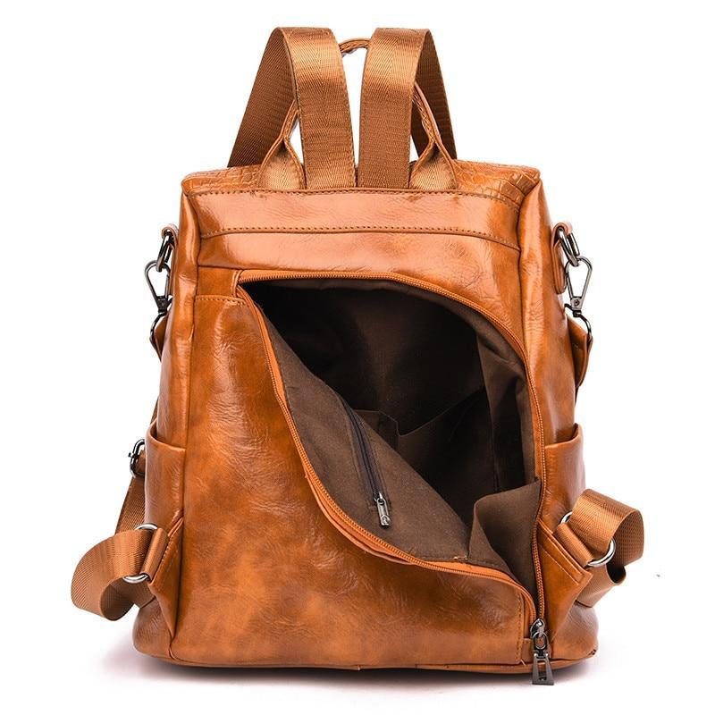 Brown leather backpack with rear hidden pocket